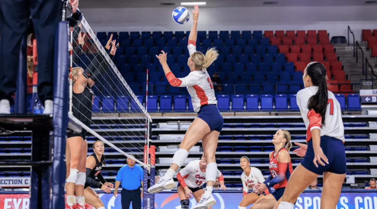 FAU middle blocker Maggie Allred attacking at the net against Ball State University on Sept. 1. 